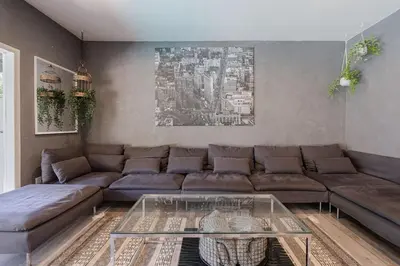 a living room with a couch and a glass table at Mulholland Drive with Spa & Game Room in Los Angeles