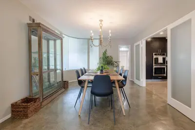 a dining room with a wooden table and chairs at Mulholland Drive with Spa & Game Room in Los Angeles