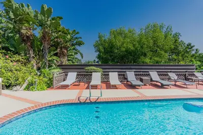 a group of chairs and a swimming pool at Mulholland Drive with Spa & Game Room in Los Angeles