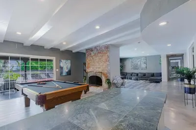 a living room with a pool table and a fireplace at Mulholland Drive with Spa & Game Room in Los Angeles