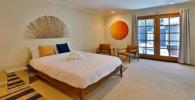 a bedroom with a bed and a table with chairs at City Paradise Saltwater Pool-Spa and Ping-Pong in Los Angeles