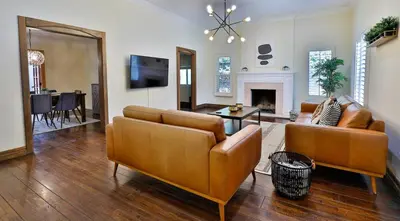 a living room with two couches and a fireplace at City Paradise Saltwater Pool-Spa and Ping-Pong in Los Angeles