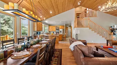 a dining room with a long table and chairs at Sleeps 27 2 Homes Near the Lake Hot Tub Views Castle Glen Estates in Big Bear Lake