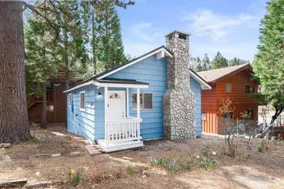 a blue tiny house with a chimney at Bluebird Cabin, Indoor Fireplace, Next to Lake! in Green Valley Lake