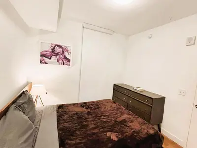 a bedroom with a bed and a dresser in it at Boutique KTown Stays With Breathtaking Rooftop Views in Los Angeles
