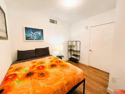 a bedroom with a large bed with flowers on it at Boutique KTown Stays With Breathtaking Rooftop Views in Los Angeles