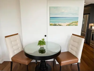 a dining room with a glass table and two chairs at Boutique KTown Stays With Breathtaking Rooftop Views in Los Angeles