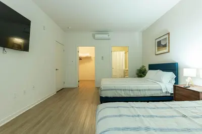 a hotel room with two beds and a television at Elegant & Charming 2BR Apartment in Glendale