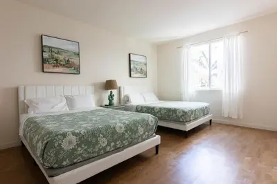 a bedroom with two beds and a window at Lovely and Modern Apartment in Glendale