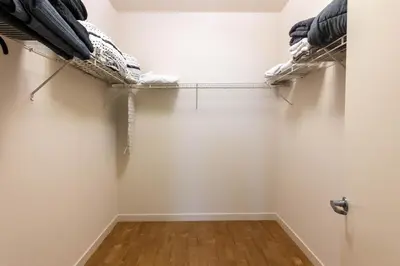 a walk in closet with two shelves at Lovely and Modern Apartment in Glendale