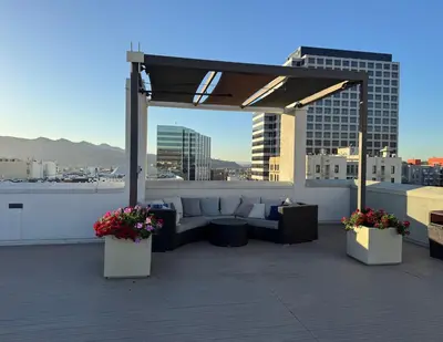 a patio with a couch on a roof at Lovely and Modern Apartment in Glendale