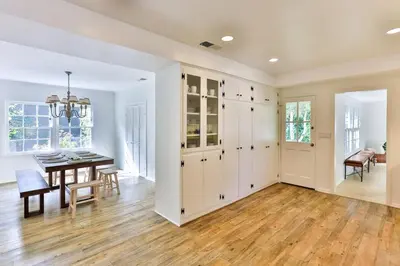 a dining room and living room with a table and chairs at Pool & Spa Ping-Pong Mini-Golf & 5BR in Sherman Oaks