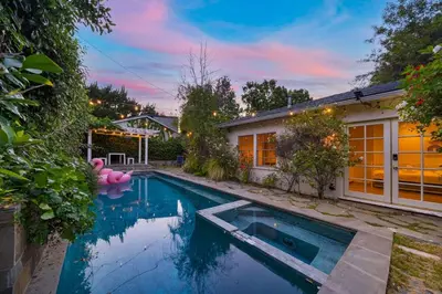 a swimming pool in front of a house at Pool & Spa Ping-Pong Mini-Golf & 5BR in Sherman Oaks