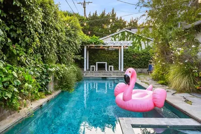 two pink inflatable flamingos in a swimming pool at Pool & Spa Ping-Pong Mini-Golf & 5BR in Sherman Oaks