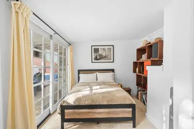 a bedroom with a bed and a large window at The Robinson Tree House in Silver Lake in Los Angeles