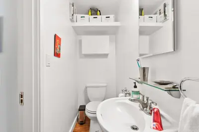 a white bathroom with a sink and a toilet at The Robinson Tree House in Silver Lake in Los Angeles