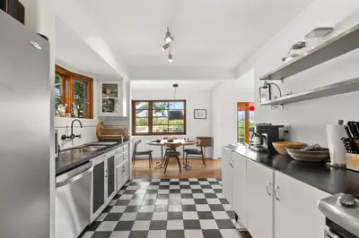 a kitchen with a black and white checkered floor at The Robinson Tree House in Silver Lake in Los Angeles