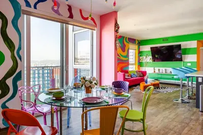 a dining room with a table and chairs at Colorful penthouse near DTLA in Los Angeles