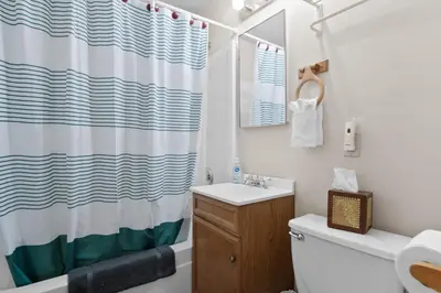 a bathroom with a sink and a shower curtain at Comstock Cabin by Rather Be Properties in Big Bear Lake