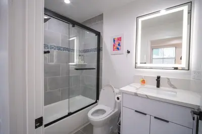 a bathroom with a shower and a toilet and a sink at Stylish Private Room by Downtown LA with Private Parking in Los Angeles