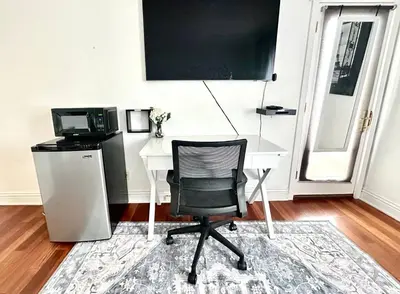 a desk with a computer and a chair in a room at Room with a view in the Hills of Studio City -B in Studio City