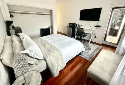 a bedroom with a bed and a desk with a piano at Room with a view in the Hills of Studio City -B in Studio City