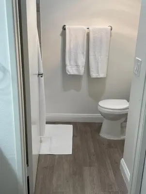 a bathroom with white towels and a toilet at Hollywood Spectacular Loft FREE Designated parking in Los Angeles