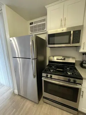 a kitchen with a stainless steel refrigerator and a stove at Hollywood Spectacular Loft FREE Designated parking in Los Angeles