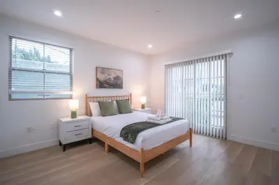 a white bedroom with a bed and a window at Stylish Private Room by Downtown LA in Los Angeles