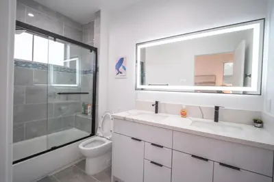 a bathroom with a toilet and a sink and a mirror at Stylish Private Room by Downtown LA in Los Angeles