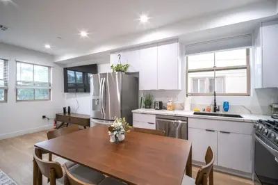 a kitchen with a wooden table and a dining room at Stylish Private Room by Downtown LA in Los Angeles