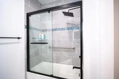 a shower with a glass door in a bathroom at Stylish Private Room by Downtown LA in Los Angeles