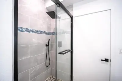 a shower with a glass door in a bathroom at Stylish Private Room by Downtown LA in Los Angeles