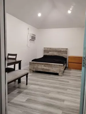 a bedroom with a bed and a bench in a room at Hollywood Homes of Love in Los Angeles