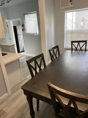 a dining room table and chairs in a kitchen at Hollywood Homes of Love in Los Angeles