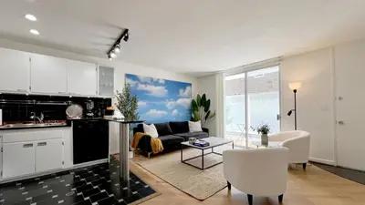 a kitchen and a living room with a couch at Seabreeze Hideaway one bedroom in Los Angeles
