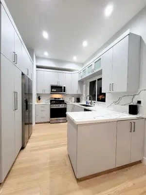 a white kitchen with white cabinets and appliances at Newly constructed 2 bedroom by La Cienega Plaza with parking, modern kitchen, washer dryer and very central to attractions in Los Angeles