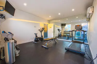 a gym with several treadmills and elliptical machines at Industrial Style 2BR Condo Downtown LA With Rooftop! in Los Angeles