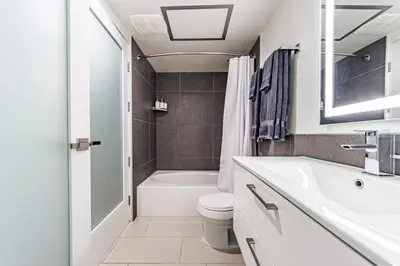 a white bathroom with a sink and a toilet at Modern Loft 1BR in Downtown LA! in Los Angeles