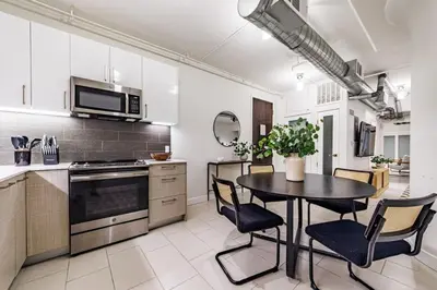 a kitchen with a table and chairs in a kitchen at Modern Loft 1BR in Downtown LA! in Los Angeles