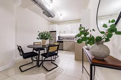 a kitchen and dining room with a table and chairs at Modern Loft 1BR in Downtown LA! in Los Angeles