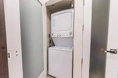 a washer and dryer in a small room at Modern Loft 1BR in Downtown LA! in Los Angeles