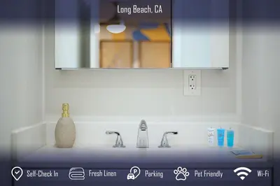 a bathroom counter with two sinks and a mirror at Chic 4B2B Townhome Private Pool in Long Beach