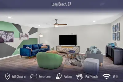 a living room with couches and a flat screen tv at Chic 4B2B Townhome Private Pool in Long Beach