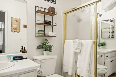a white bathroom with a toilet and a shower at Summit Slope Side in Big Bear Lake