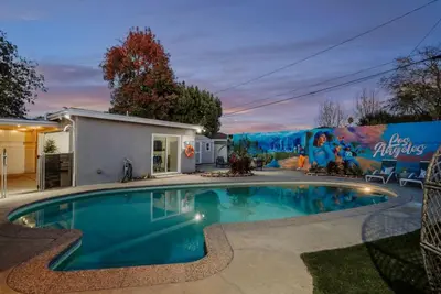 a swimming pool in front of a house at Blue Haven Solar Pool Heat Parking Billiards in Long Beach
