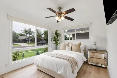a bedroom with a bed and a large window at Sunny Daze - Heated Pool - Billiards - Games in Placentia
