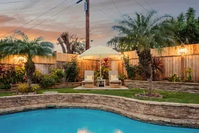 a backyard with a swimming pool and a fence at Sunny Daze - Heated Pool - Billiards - Games in Placentia