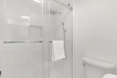 a bathroom with a glass shower with a toilet at Sunny Daze - Heated Pool - Billiards - Games in Placentia