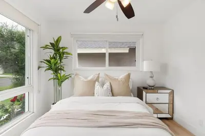 a white bedroom with a bed and a window at Sunny Daze - Heated Pool - Billiards - Games in Placentia
